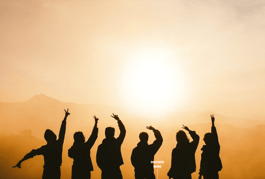 Silhouettes of young people celebrating together at sunset